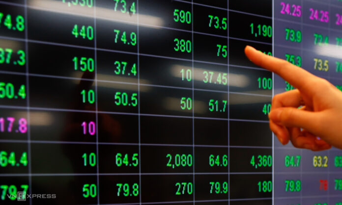 Nhà đầu tư đang theo dõi bảng điện tại trụ sở một công ty chứng khoán ở TP HCM