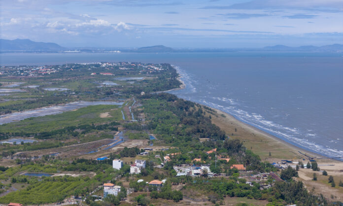 Coastal landscape with lush greenery.